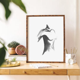 Abstract watercolour artwork of female figure framed on a desk