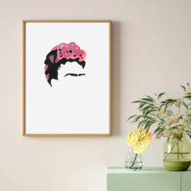 Abstract painted portrait of Frida Kahlo framed on a pink wall